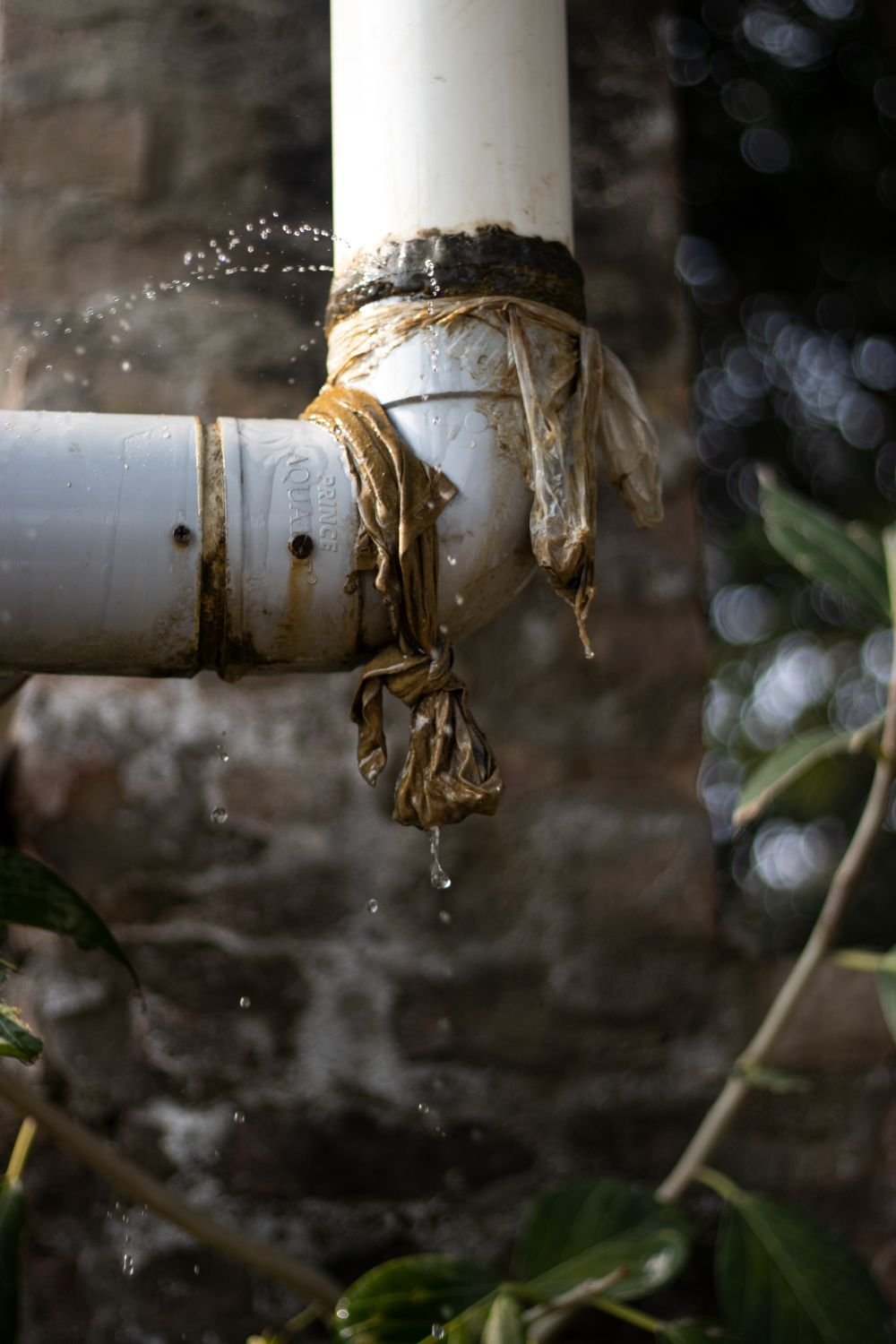 Water spraying from a damaged outdoor pipe joint